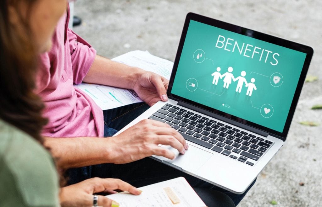 Reviewing employee benefits packages on a laptop computer.